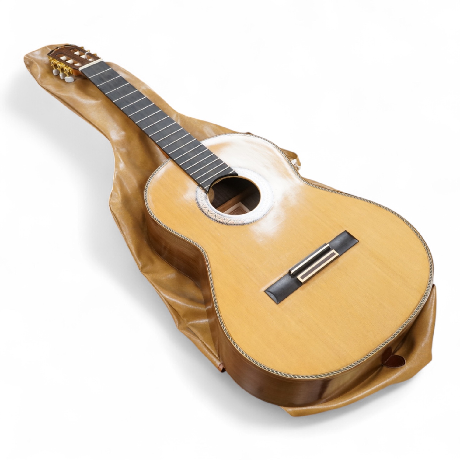 A handmade cedar, Indian Rosewood and ebony classical guitar by 'an English Luthier', with label to the inside of the body, together with a soft case.